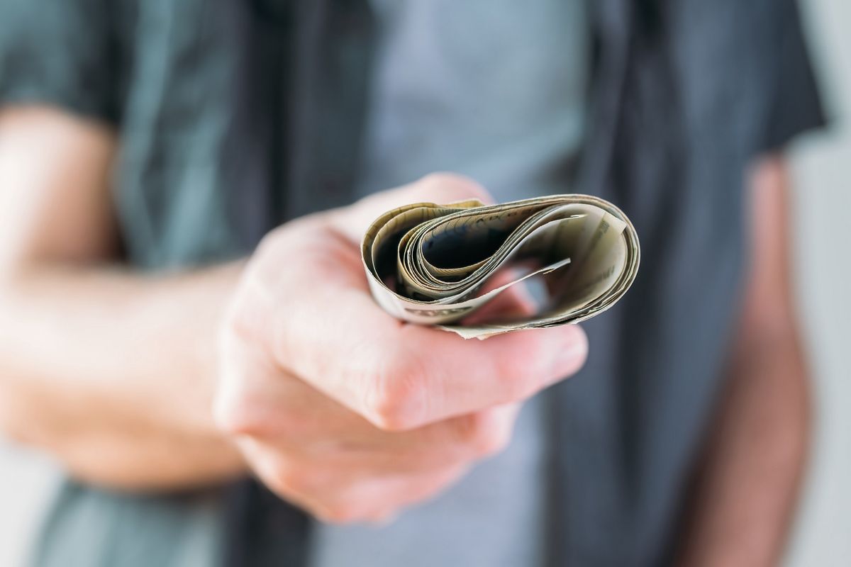 Man holding Serbian currency Dinar paper banknotes