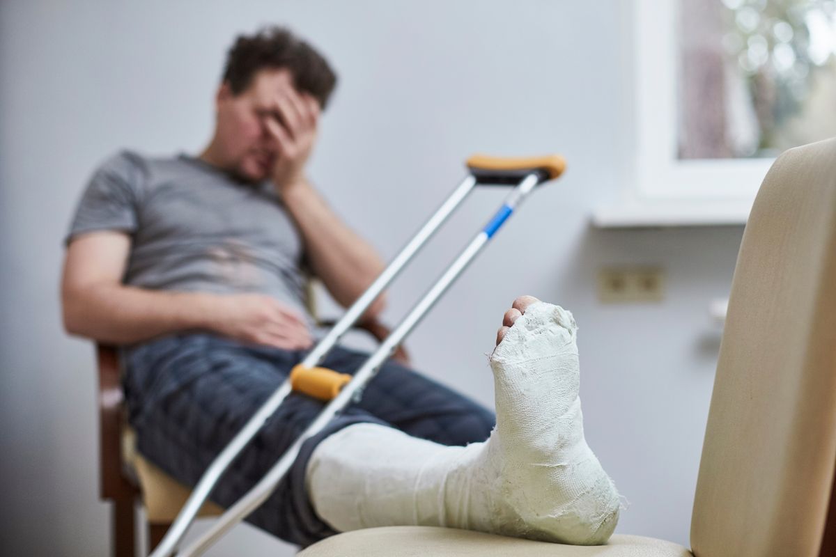 A,Sad,Man,With,A,Broken,Leg,Sits,On,A